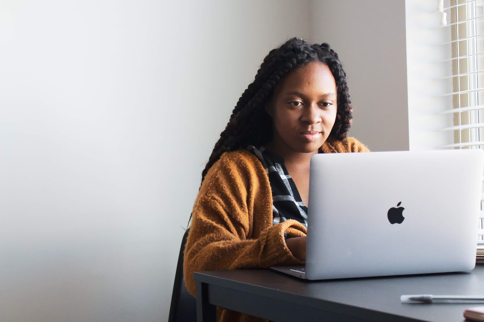 Person preparing for a coding bootcamp at their desk with a laptop