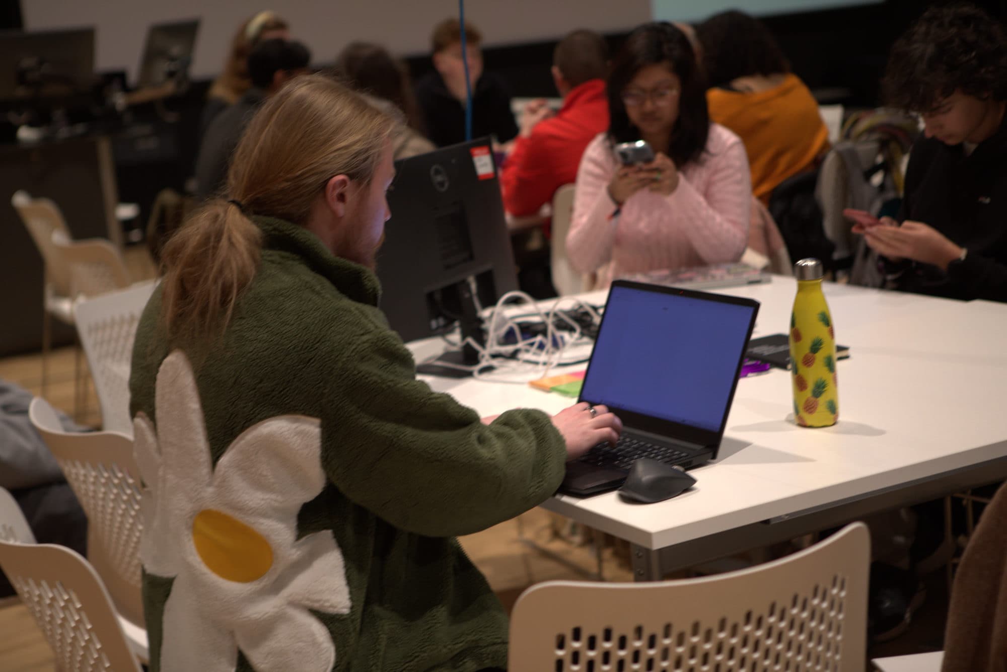 A participant building her team's project at HackEd Norwich 2026