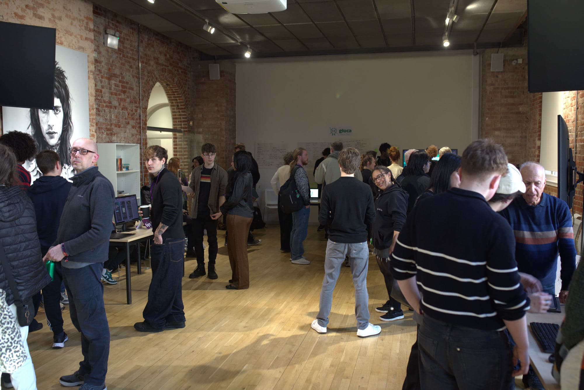 Visitors moving between project stands at the HackEd Norwich 2026 showcase