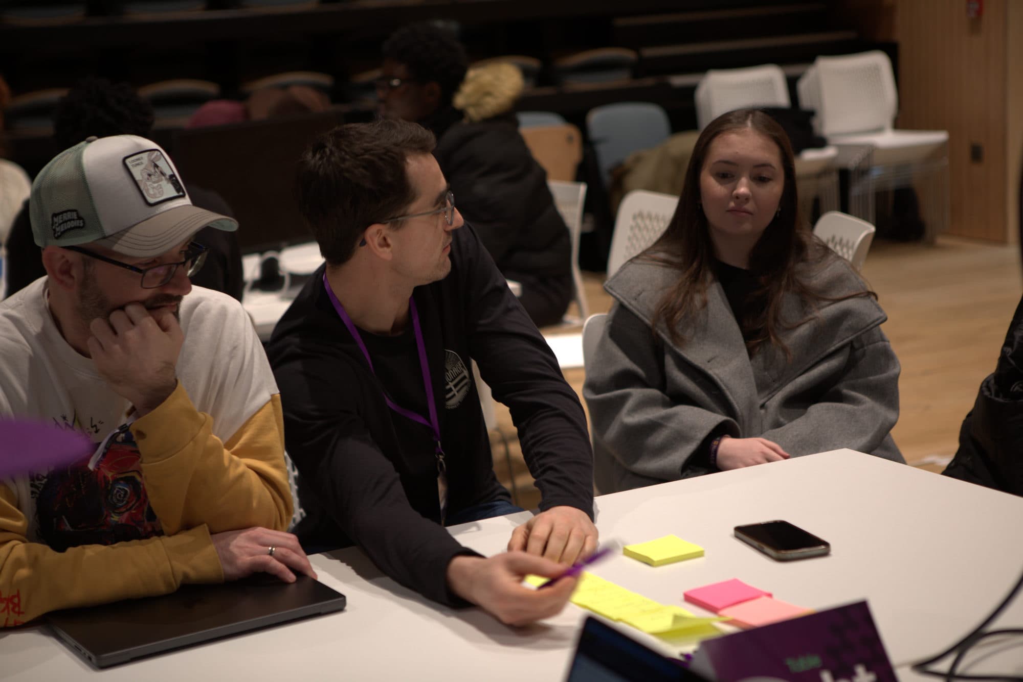 A team talking through their idea over sticky notes at HackEd Norwich 2026
