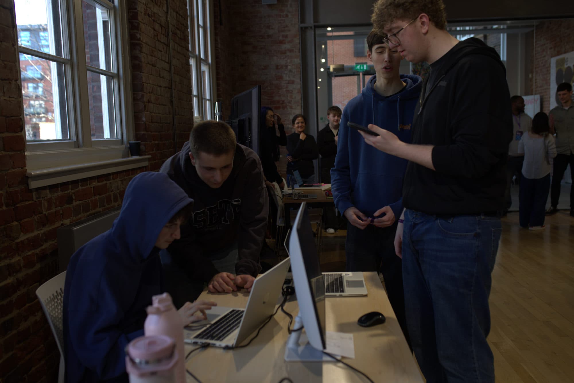 Participants working together at a shared machine during HackEd Norwich 2026