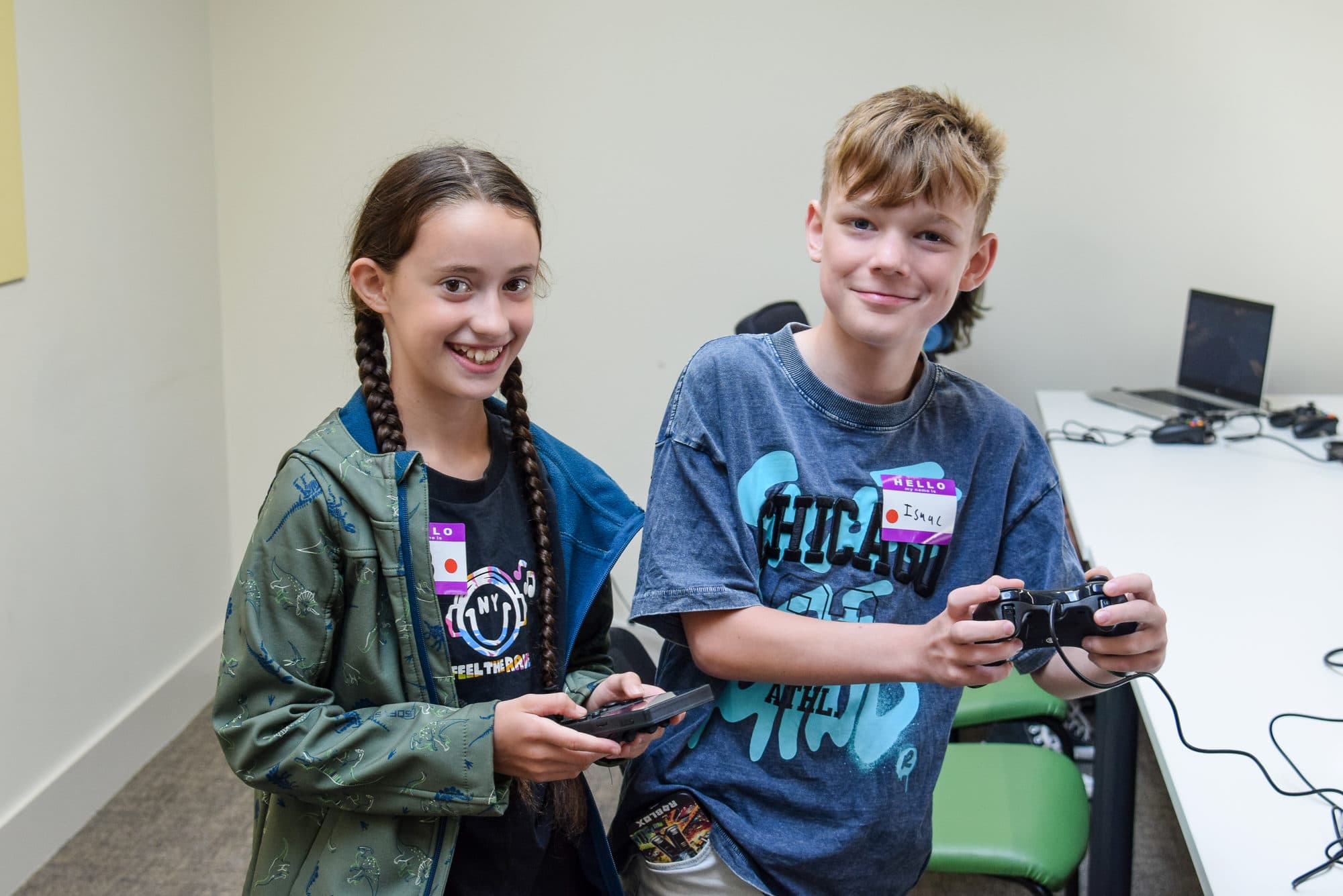 Two smiling participants with controllers at the TechYouth Gaming Day