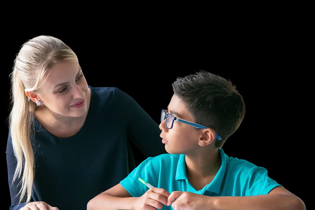 A teacher supporting a student in class.