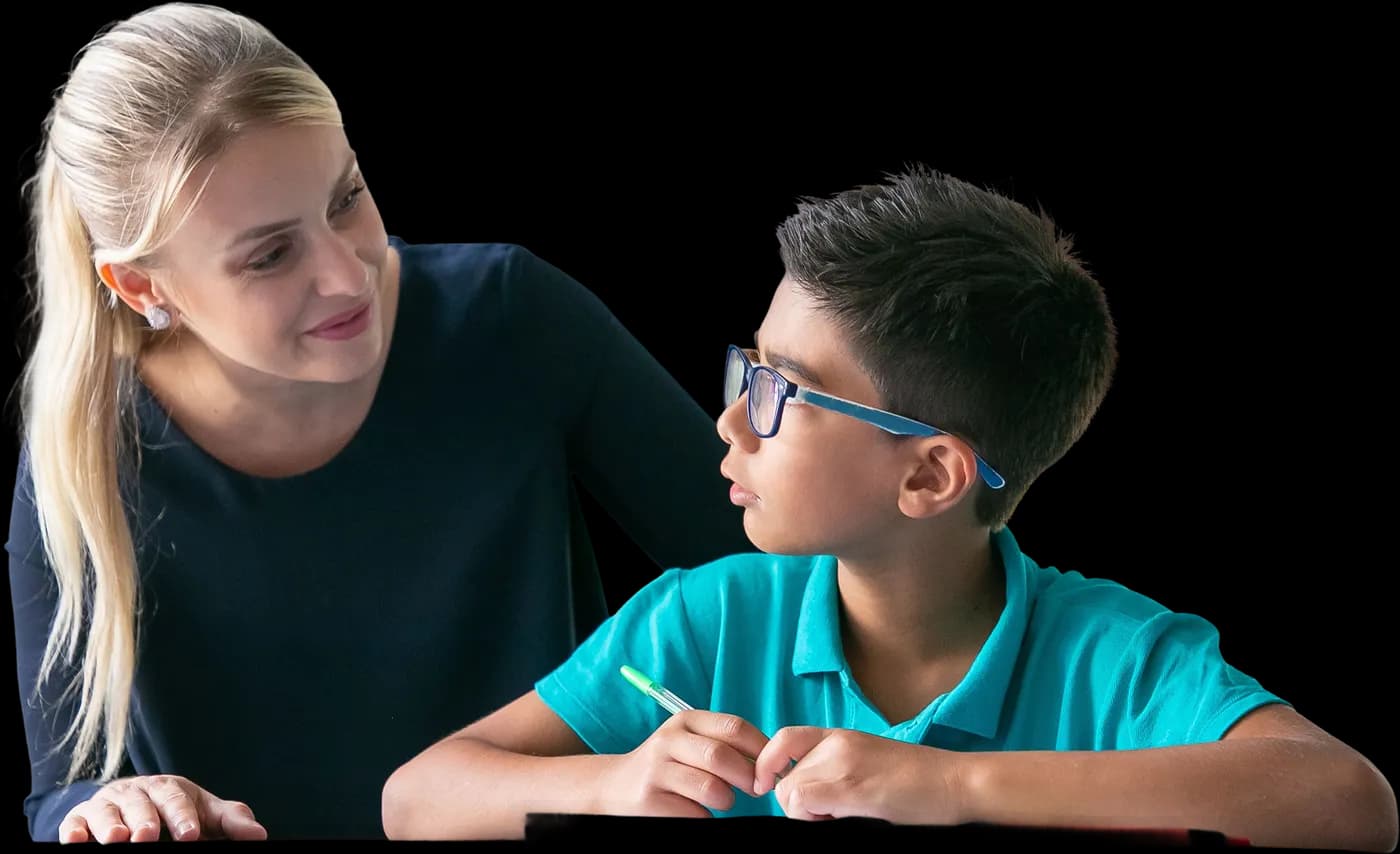 A teacher helping a pupil with his work in class.