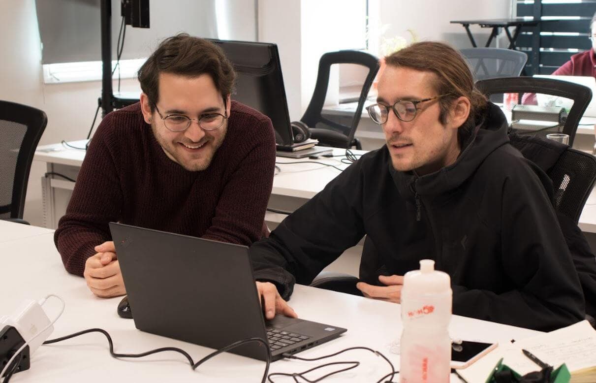 Young professional learning technical skills at a desk as part of a tech apprenticeship programme