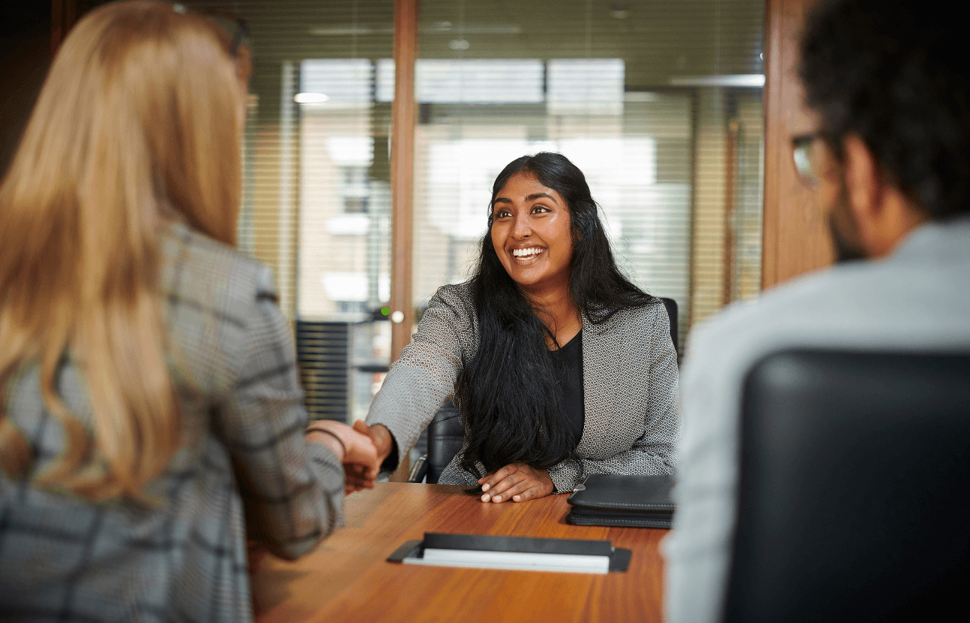 Career changer preparing for their first tech role with a laptop and portfolio