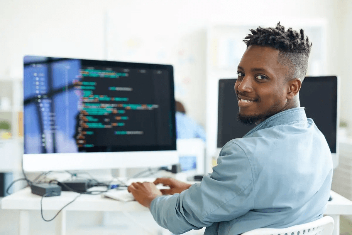 Student working at a computer, with two screens