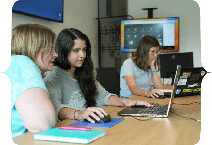 A group working together around laptops in a collaborative session