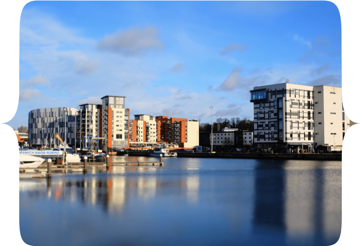 A picture overlooking a river, with high-rise apartments in the distance