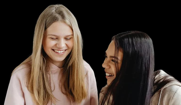 Two young students smiling together.