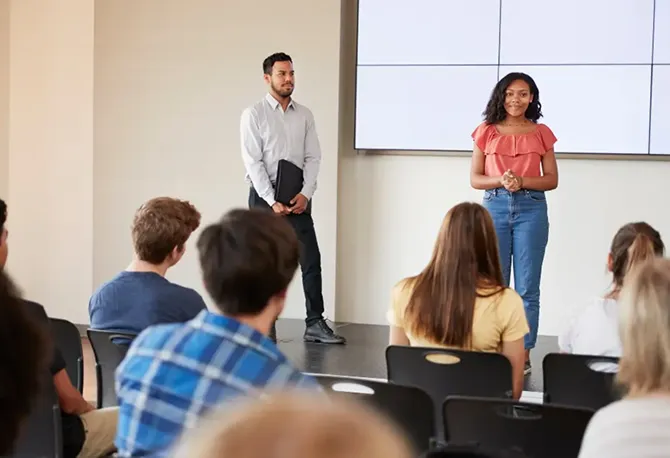 A TechFirst youth instructor presenting a workshop to a class.