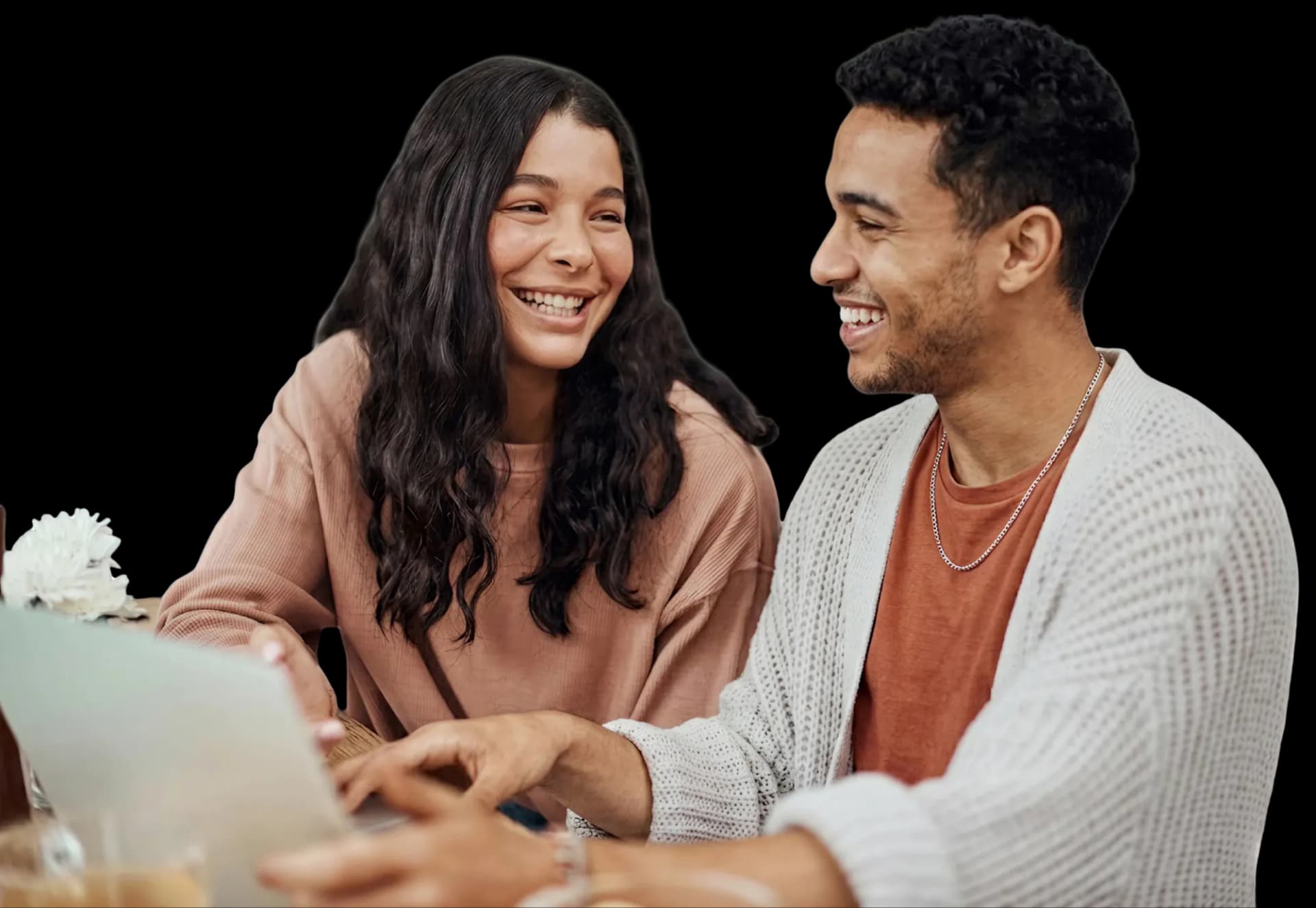A student and mentor working together at a laptop.