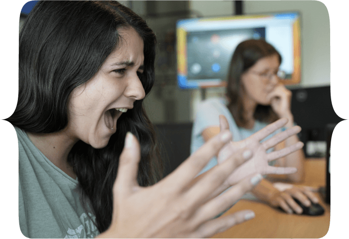A Woman exclaiming in-front of her laptop! Arms up high in frustration.
